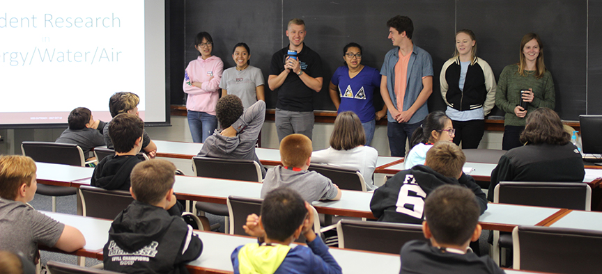 Lafayette students talk at the blackboard.
