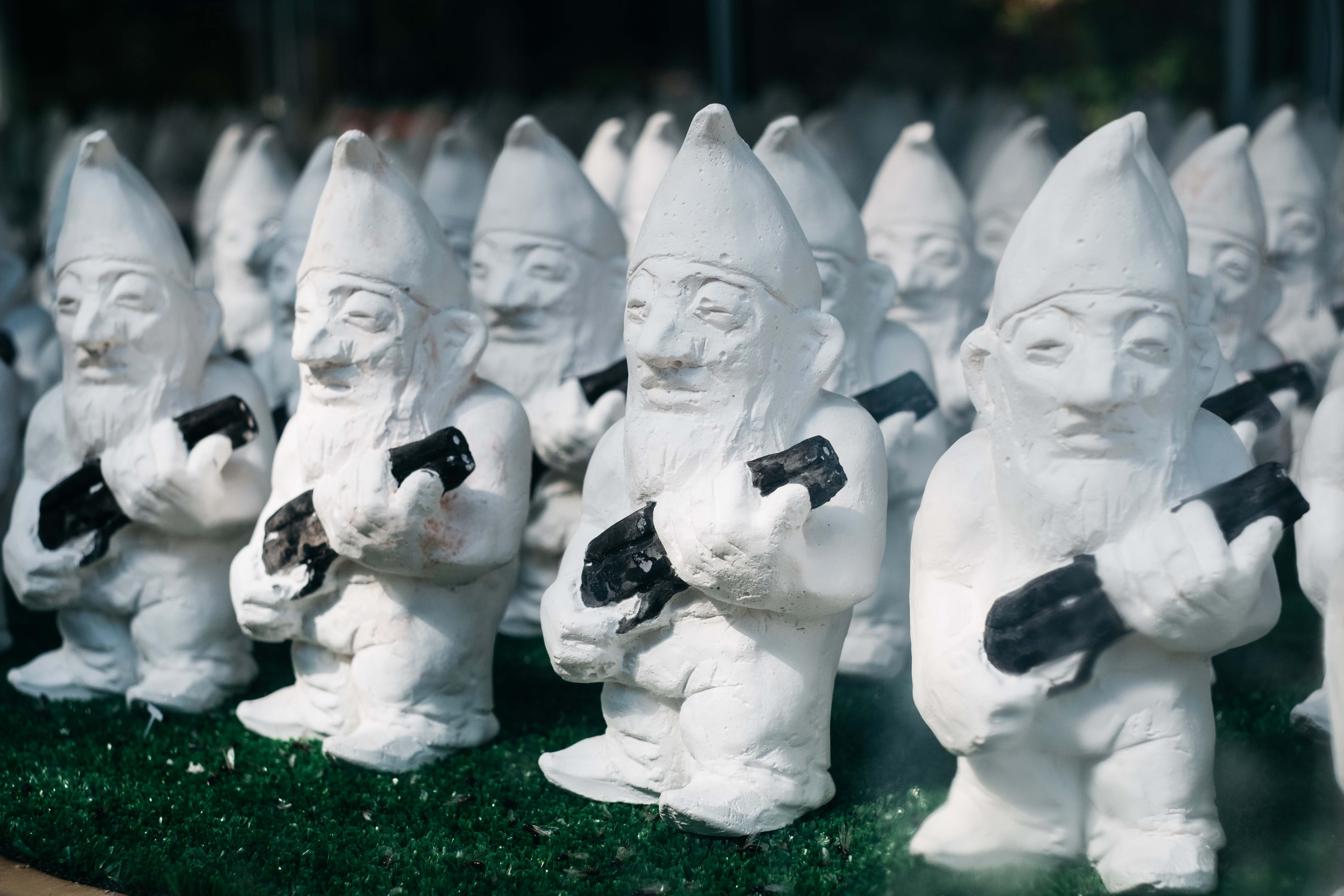 Sculptures of gnomes holding guns