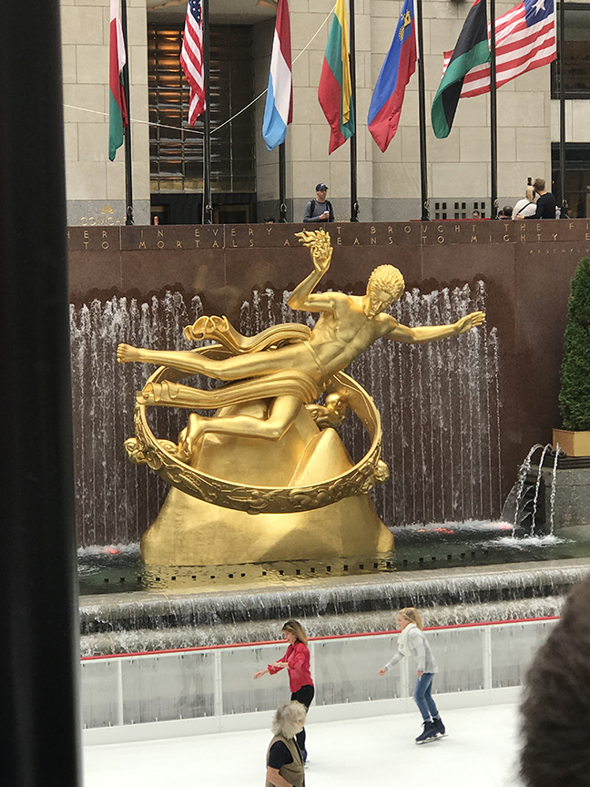 A golden-hued statue of Prometheus in New York City