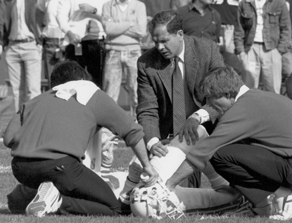 Bert Zairns tends to an injured player.