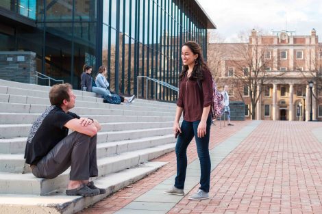 A professor and student talk on the steps leading up to Skillman Library