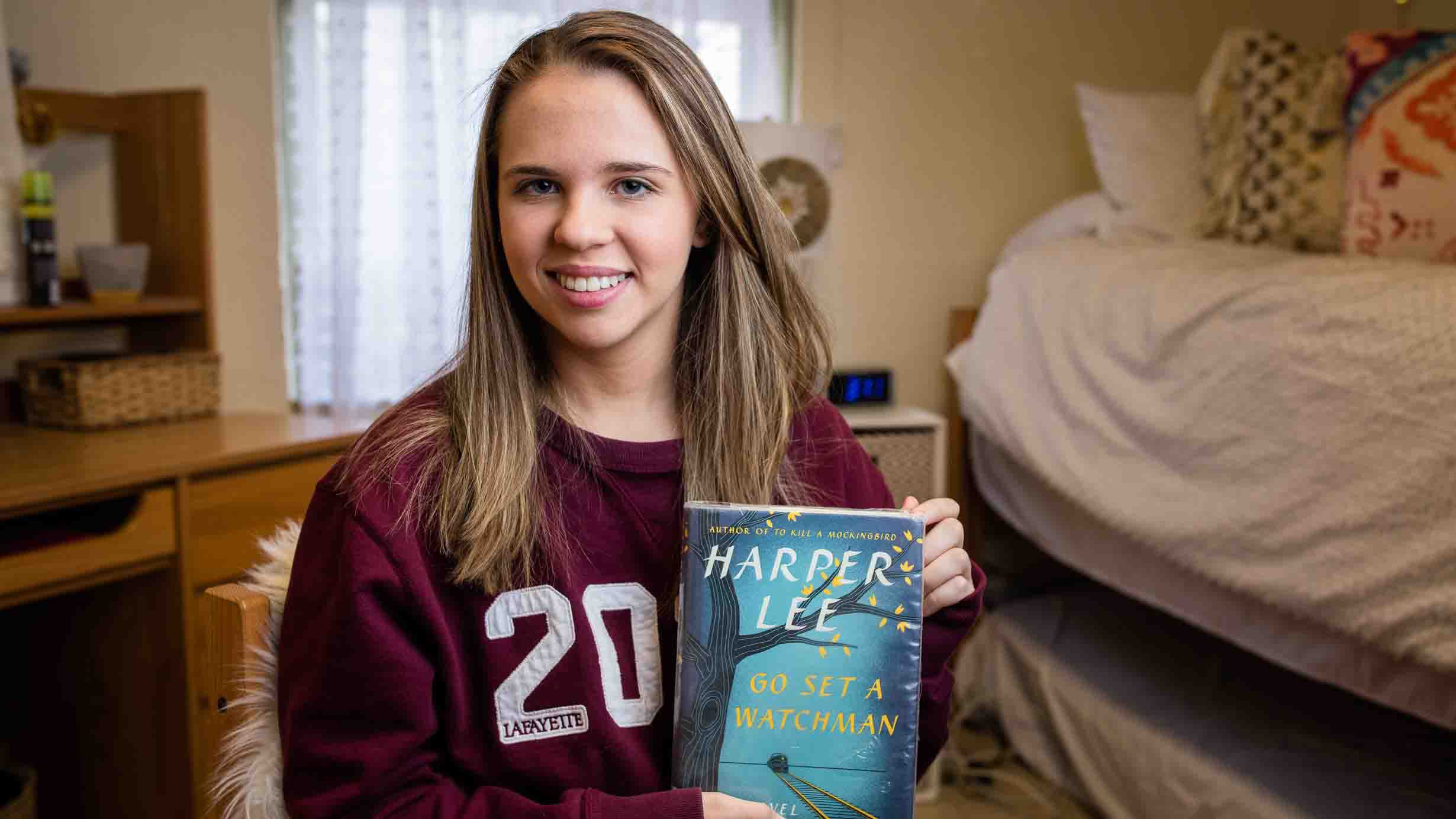 Julia Hoffman '20 holds a copy of the book Go Set a Watchman by Harper Lee.