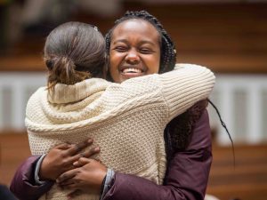 Laila Lalami, author of this year's Community Reading, Hope and Other Dangerous Pursuits, hugs a student at Colton Chapel.