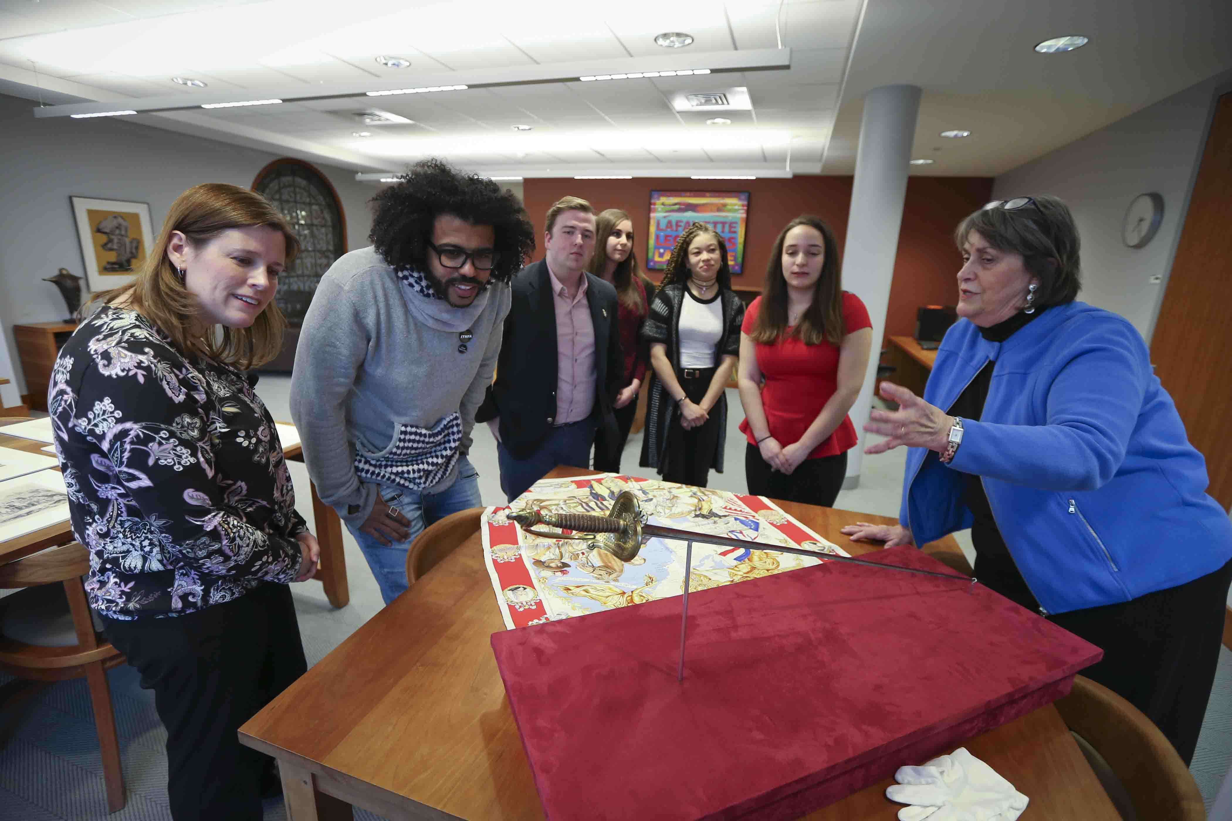 Hamilton star Daveed Diggs with Lafayette College Archivist Diane Shaw and others look at the Marquis de Lafayette's sword.