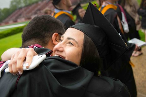 Friends hug after Commencement.