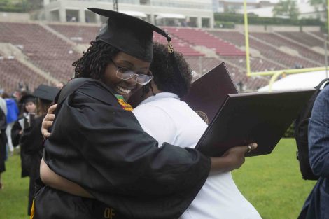 A mother and daughter hug after Commencement.