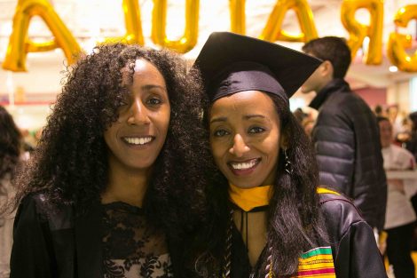 A mother and daughter pose for a photograph after Commencement.