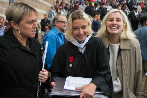 A family smiles after Commencement.