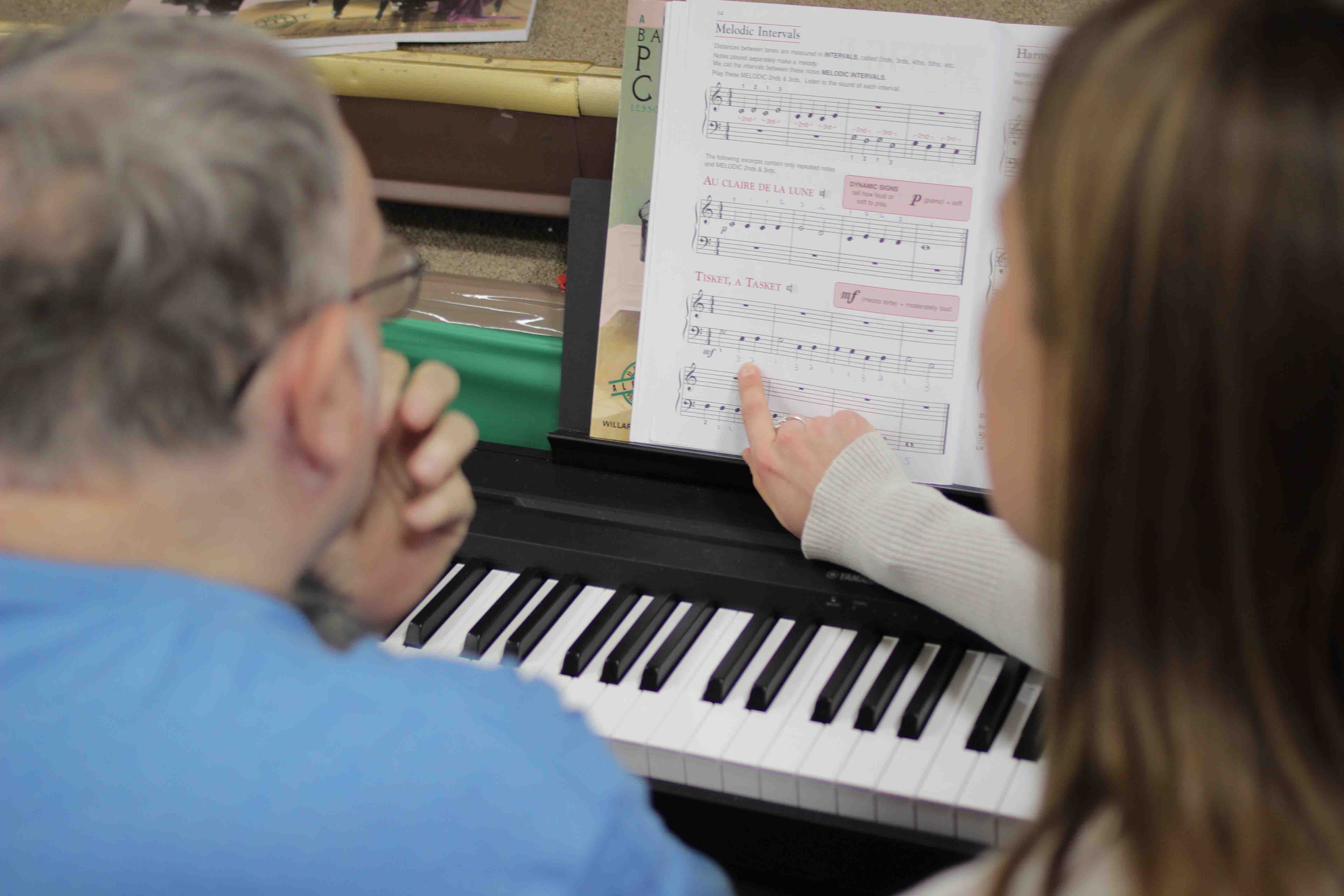 Carolyn McDonough '18 gives a piano lesson to a senior citizen at Easton Area Lifestyle Campus.