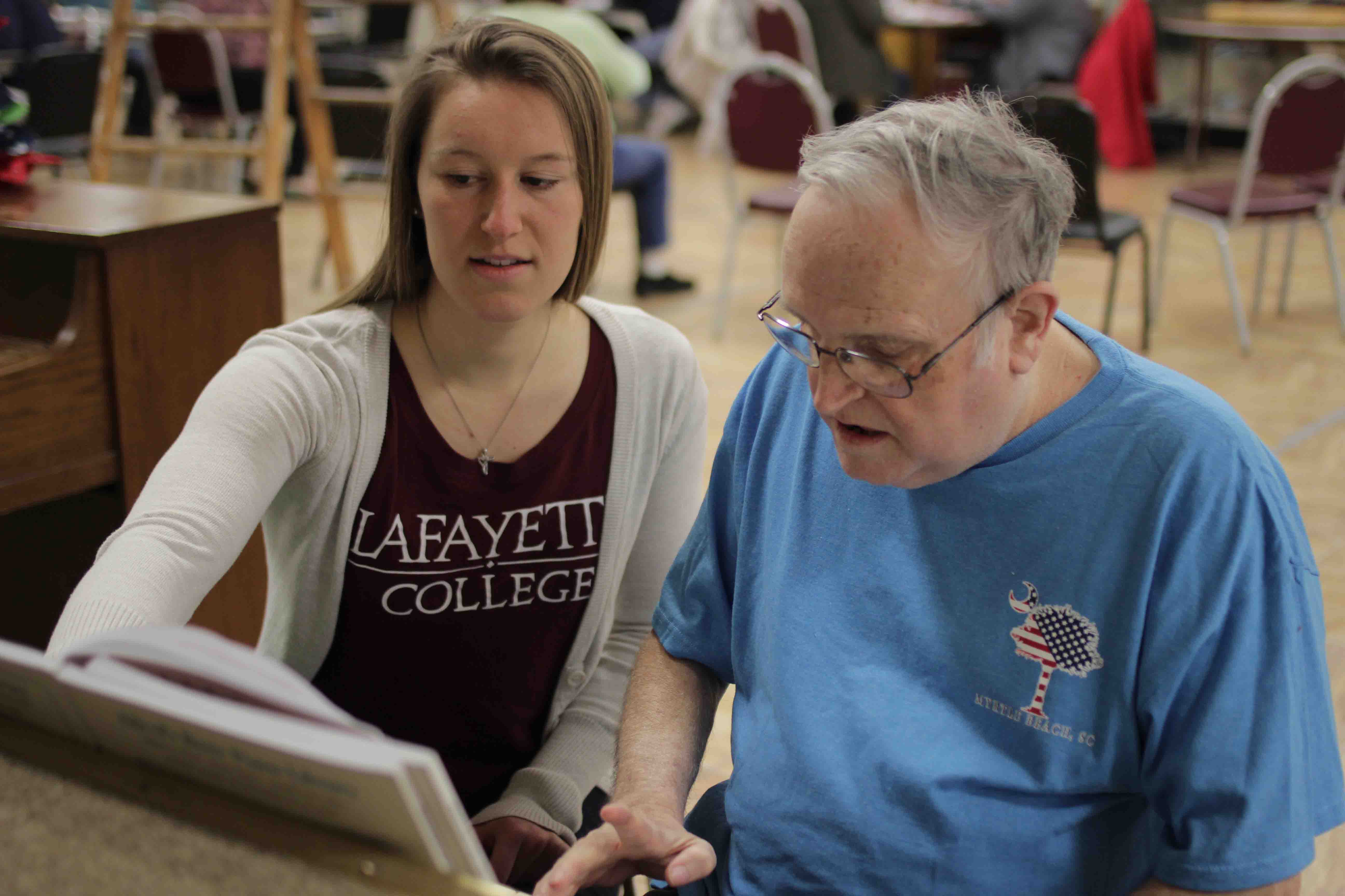 Carolyn McDonough teaches piano at Easton Area Lifestyle Center to a senior citizen.