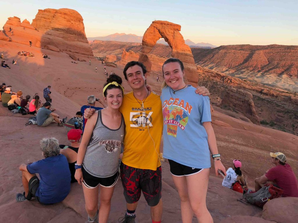 Molly Martindale ’19, Griffin Williams ’19, and Lucy Moeller ’21 against a backdrop of Delicate Arch in Arches National Park