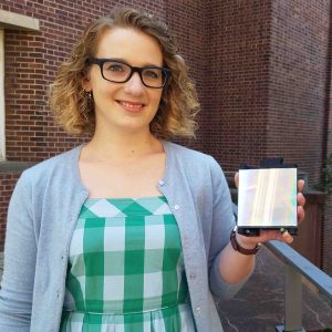 Annemarie Exarhos Hawley holds a diffraction grating.