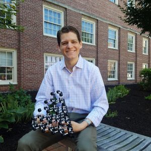 Chris Hawley holds an atomic model of the structure of silicon.