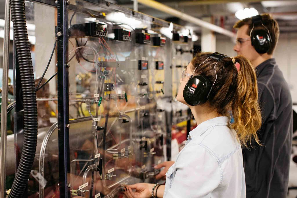 Andrew Schmid ’20 and Alyssa Devin '19 look at instrument readings as part of their work on the expansion tube in a mechanical engineering lab.