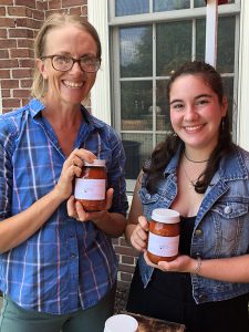 Marina Cantor '21 and Lisa Miskelly hold jars of salsa.