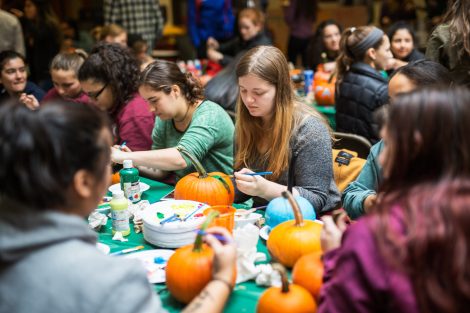 Students paint pumpkins in the Farinon Center during the annual Fall Fest.
