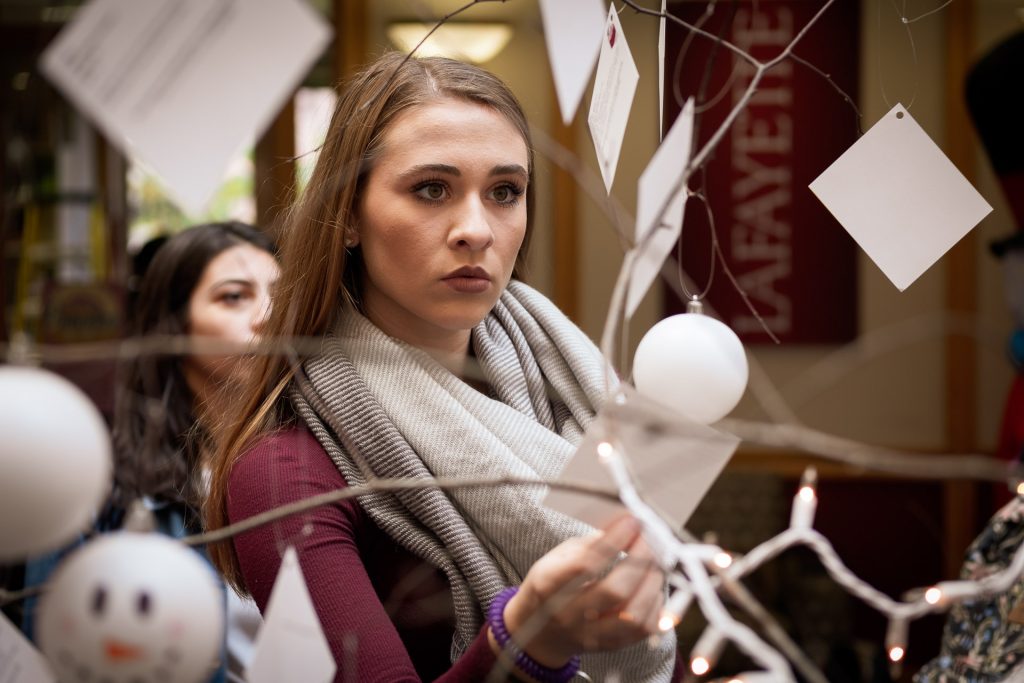 A student looks at a gift tag in the Farinon Center.