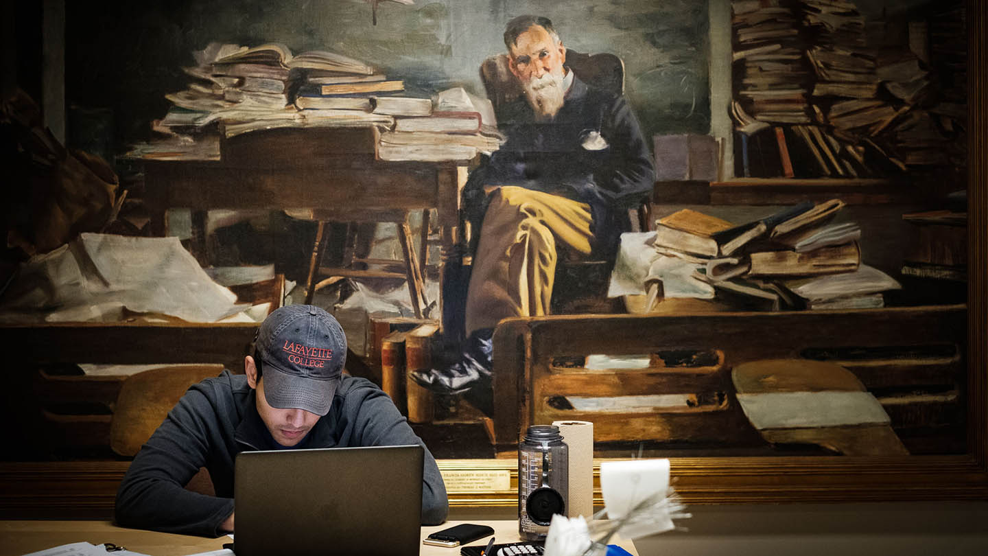 A student studies in front of a portrait of the late Francis A. March, professor of English at Lafayette College.