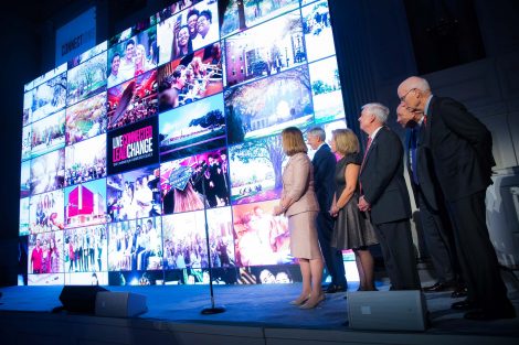 President Alison Byerly and others stand on stage at the annual holiday party in New York City.