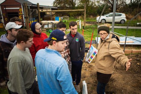Lisa Miskelly, assistant director of food and farm, talks to members of Phi Psi fraternity helping with the building of a hoop house, a 22-by-21-foot structure that will help LaFarm extend its growing season earlier in spring and later in fall.