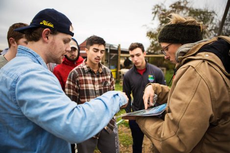 Lisa Miskelly, assistant director of food and farm, talks to members of Phi Psi fraternity helping with the building of a hoop house, a 22-by-21-foot structure that will help LaFarm extend its growing season earlier in spring and later in fall.