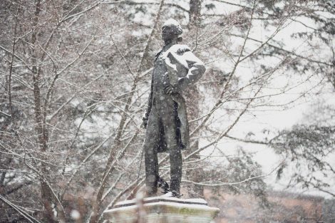 the marquis de lafayette statue shivers in the snow as it wears a white cap of snow