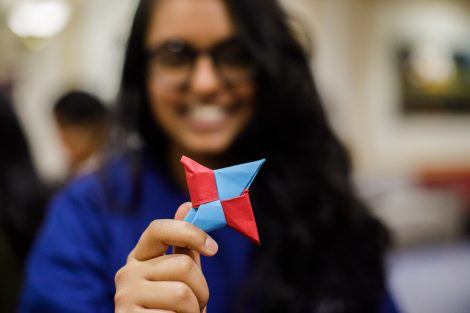 A student holds origami at the Lunar New Year celebration.