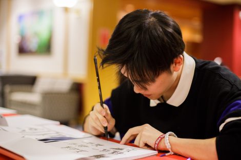 A student writes calligraphy at the Lunar New Year celebration.