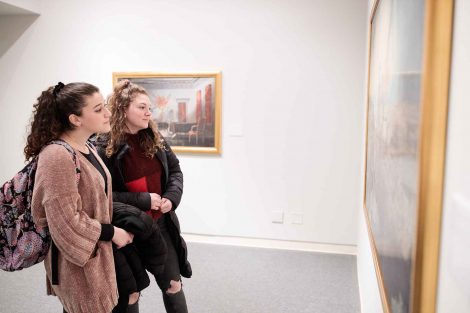 Students in the gallery contemplate Cedomir Vasic's work.