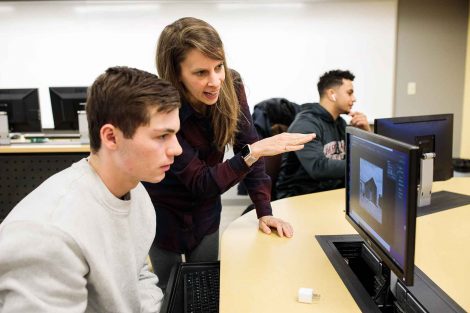 Photo instructor helps student manipulate an image.