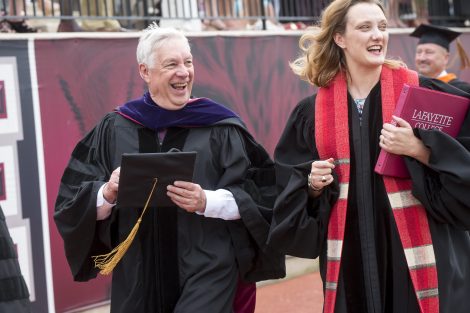 Ed Ahart and Alex Hendrickson laugh as they walk at Commencement.