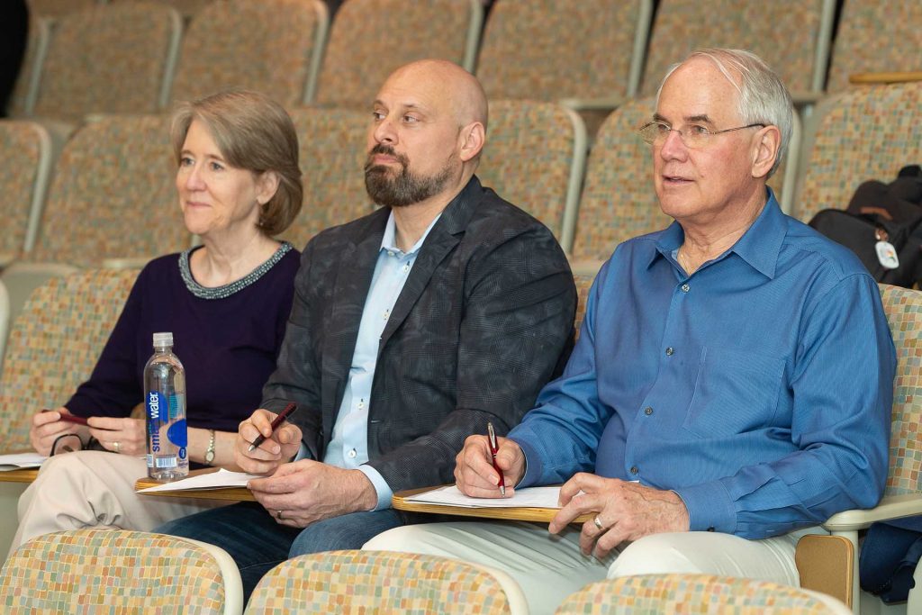 Judges Kathleen Williams P'15, Paul Staubi '88, and Roger Newton '72 sit and listen to presentations.