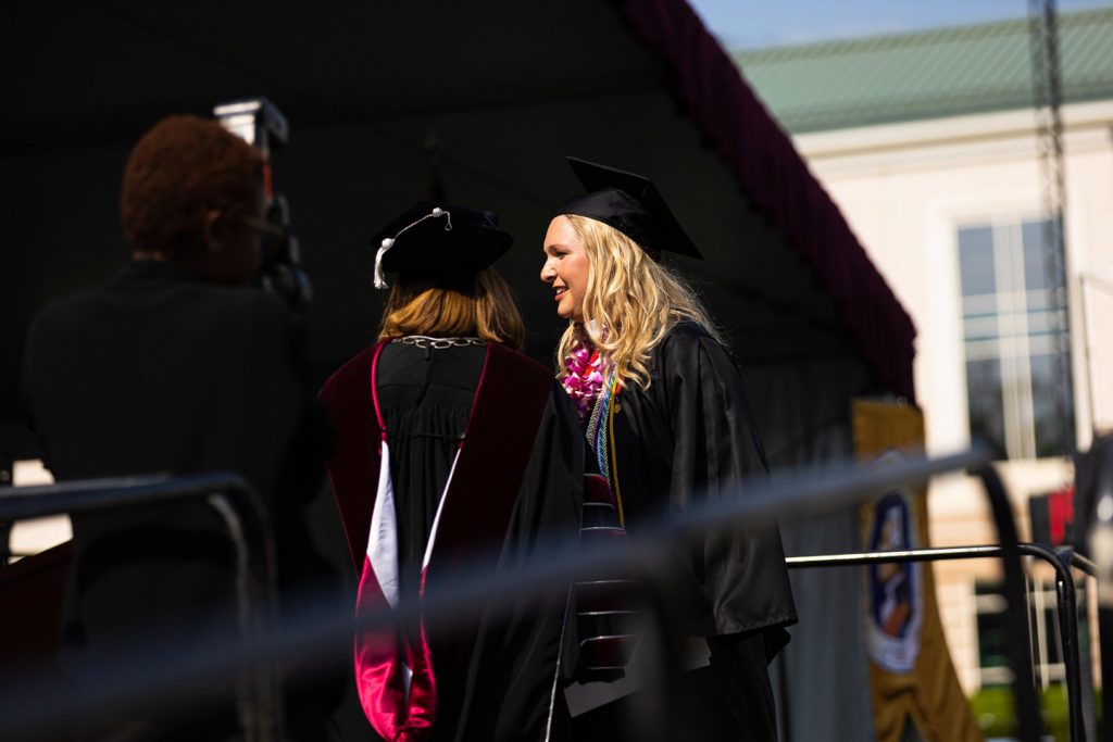 Reeve Lanigan '19 stands next to Alison Byerly on the Commencement platform.