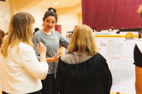 Students explain their research to visitors at the 2019 spring poster session in Kamine Gymnasium in Kirby Sports Center.