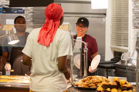 Students chow down on breakfast food late at night, served up by faculty and staff.