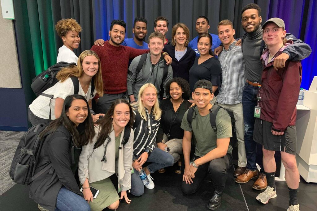 Students pose together in big group with CFO of Alphabet