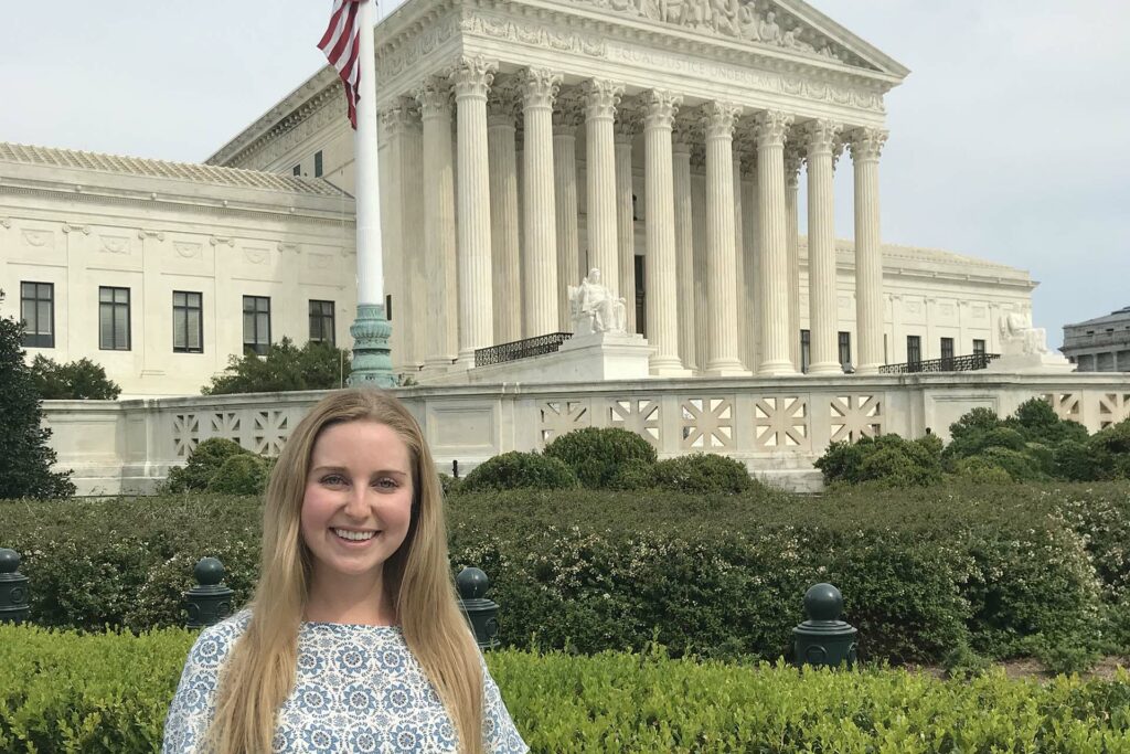 Student poses in front of the U.S. Supreme Court