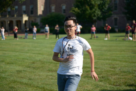 international student runs on quad