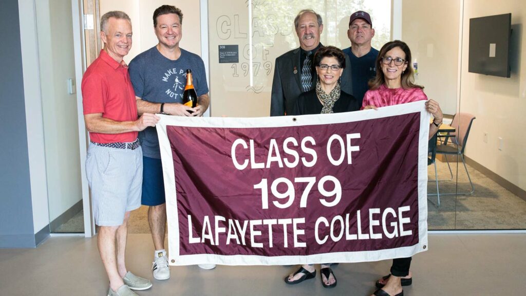 Alumni hold the Class of 1979 banner.