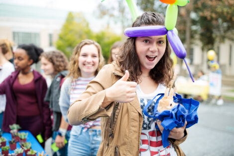 A student wears a balloon hat at Block Party