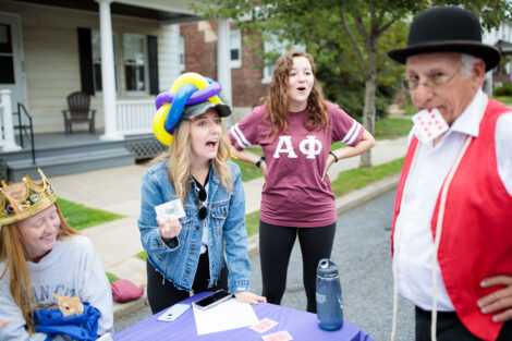 a student is fooled by a magic trick at block party