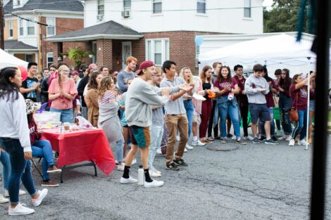 students clap for performers at block party