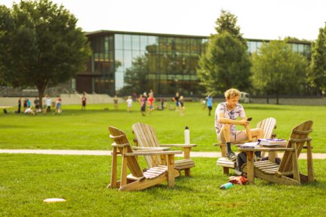 a student sits on chairs on the quad