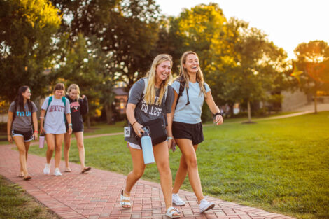 a group of students walks across the quad