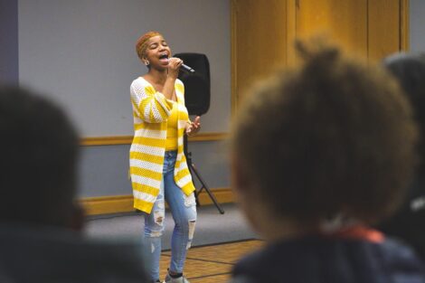 A student sings at the AfroCaribbean Showcase