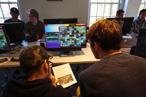 A group of students from Lafayette and Lehigh Esports clubs sit together and play video games.
