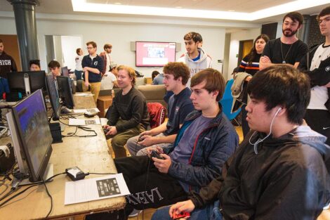 A group of students from Lafayette and Lehigh Esports clubs sit together and play video games.