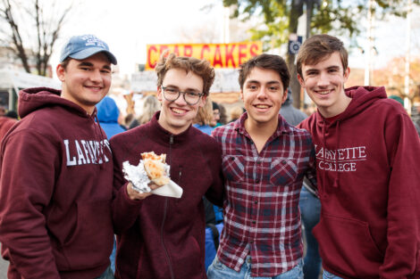 Students smiling because there is bacon at baconfest