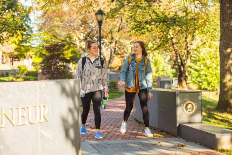 students set against the beautiful oranges and yellows of fall scenery at Lafayette