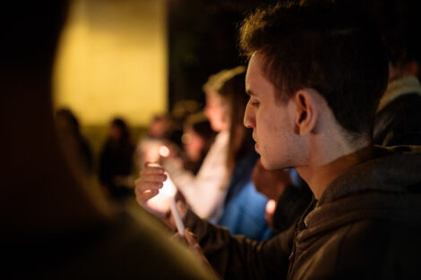 students light candles as part of the take back the night vigil